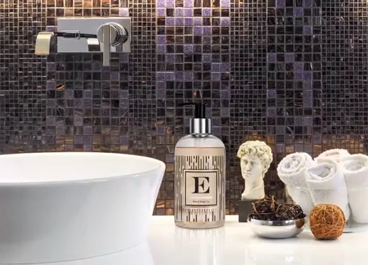 Brevä letter E bottle by a basin with mosaic tiles